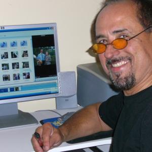 Gary Carlos Cervantes at home on his computer editing family videos.