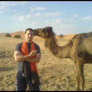Matthew Stefiuk filming on location in Morocco with Reuben the Camel
