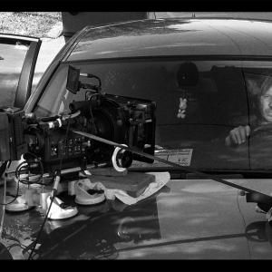 SERBIAN FILM Final adjustments for car shoot. Behind the wheel, Milos (Srdjan Todorovic).