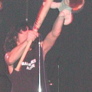 As Joey Alive (a.k.a. Joey Ramone), beating on the brat with a baseball bat during Ramones Alive performance, Salt Lake City.