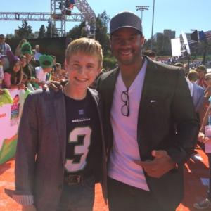 Nathan Gamble and Russell Wilson of the Seattle Seahawks on the orange carpet at The Nickelodeon Teen Sports Awards.