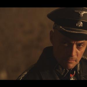 Sean Cronin as SS-MAJOR GENERAL JOSEF HEIDENBERG in ESCAPE TO GOSSAU