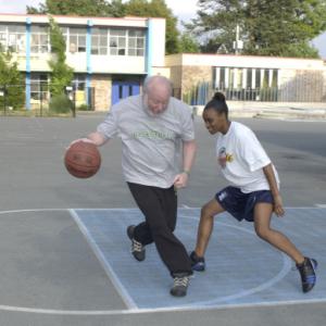 Still of Darnellia Russell and Bill Resler in The Heart of the Game (2005)