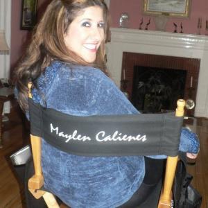 Maylen Calienes sitting in her Directors chair while filming The Three Bilinguals
