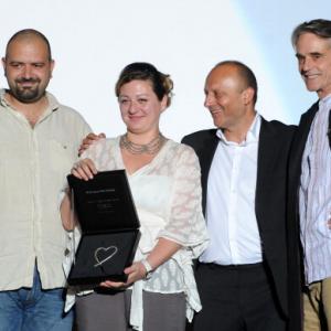 Filmmaker Diana El Jeiroudi receives with her partner Orwa Nyrabia the Katrin Cartlidge Award at Sarajevo Film Festival 2012 presented by Festival director Mirsad Miro Purivatra and Jeremy Irons