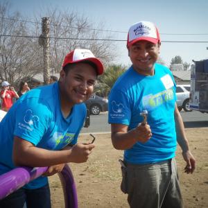 Omar Leyva and Ramiro Rodriguez, from McFarland USA, helping build a playground with McFarland Community.
