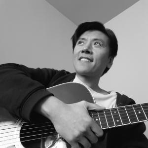 Cal Nguyen relaxing with his acoustic guitar