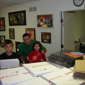 Young Cody Quinn, music manager Rob Quinn, and his daughter Megan in the label's DJ mail room.