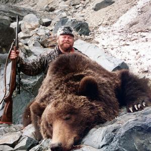 BUCK McNEELY with a Siberian Brown Bear he hunted in Russia