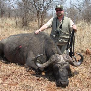 Buck McNeely with a Cape Buffalo Bull in Zimbabwe Africa.