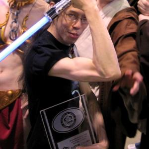 Justin Chung is inducted as an Honorary Member of the 501st Legion for his contributions to the Star Wars legacy and afterward poses with his Honorary Member plaque for the media and fans attending the surprise induction ceremony 2010