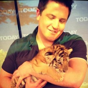David Mizejewski with a tiger cub on one of his monthly Today Show appearances.