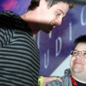 Garret Hedlund and moderator Patton Oswalt leave the Tron Legacy panel and the Disney session
