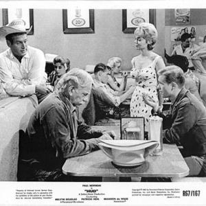 Paul Newman Melvyn Douglas Dennis Hedlundseated at rear table Yvette Vickers and Brandon De Wilde in Hud