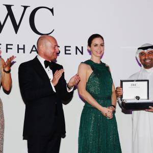 Abdullah Boushahri receiving the IWC Filmmaker Award from Emily Blunt at DIFF
