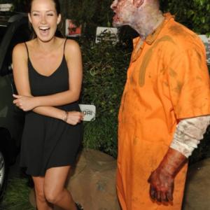 Merritt Patterson left and a walker attend Hyundai and Skybounds The Walking Dead 10th Anniversary Celebration Event on Friday July 19 2013 in San Diego Calif