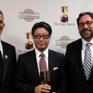 Feature production design winner Tadahiro Uesugi surrounded by presenters Pete Docter and Bob Peterson