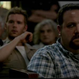 Jason Stackhouse (Ryan Kwanten) and an angry Bon Temps townsperson (Ben Zelevansky) attend a church meeting on 