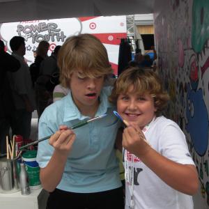Cole Sprouse & Bryce Hurless painting the wall at the Power of Youth Event 2009