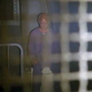 Gary-7 as the Headbanger Inmate in American Horror Story: Asylum, episode 1, Welcome to Briarcliff, in his cell at the end of a long day.