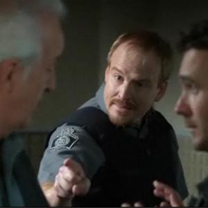 Michael Coady as Reg The Penitentiary Signin Guard with Sean McGinley and Allan Hawco