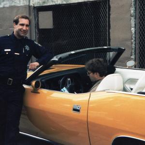 Alex as a uniformed SF police officer discusses the next scene with RJ during break on the Nash Bridges episode Knockout