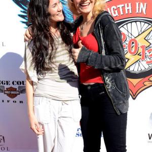 Cynthia Rose Hall shares a moment with a friend during red carpet arrivals for Strength in Support  Strength in Thunder annual celebrity motorcycle ride to benefit veterans