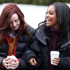 Kacey Rohl and Azie Tesfai walking with coffees on the set of This American Housewife in Vancouver Canada