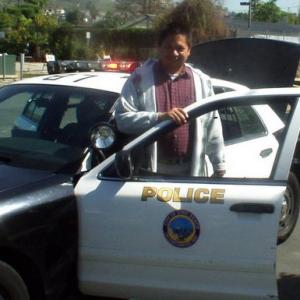 Actor Edmund K Lo is getting out of the Police Car at Long Beach City College in Long Beach Ca  wave hello to fan The Police Car is from the Long Beach City Police Department