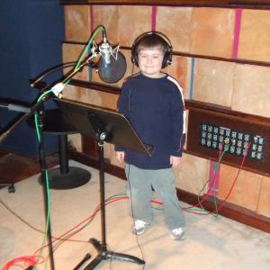 Conor Carrol in sound studio doing voiceover work