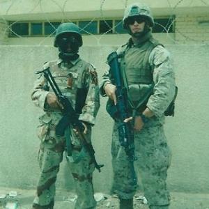 Andrew in Iraq 2005 while serving his country as a United States Marine. Next to him is an Iraqi Soldier he was training.