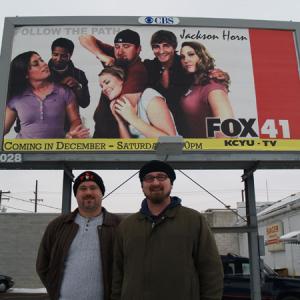 Josh Hodgins and Aaron Boltz in front of a Jackson Horn billboard