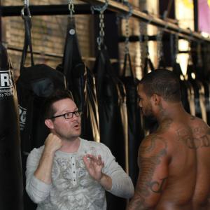 Nate Adams directs fighter James Wilson on the set of 