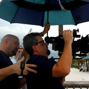 Director Donald E Reynolds watches through the camera as it rains on an early morning unloved shoot Ted Souppa holds the camera