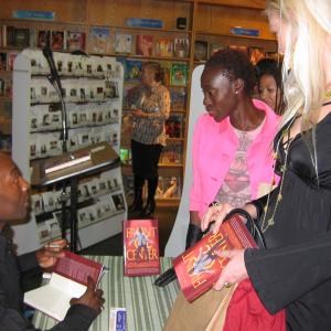 Carlton signing his award-winning book Front & Center - How I learned To live There, for Sharon Ferguson and Heather Caps.
