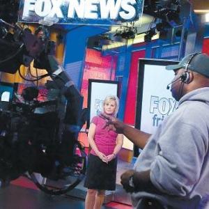 Stage Manager Joel Fulton cueing Fox and Friends co-anchor Gretchen Carlson.