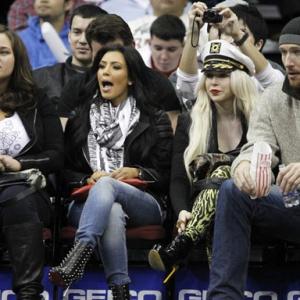 Kim Kardashian, her make-up artist Joyce Bonelli, and Peter Cornell courtside at the Prudential Center in New Jersey watching the Nets host the Pacers on February 6th, 2011