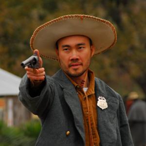 Tze Yep as Sheriff Wang in Platinum Peacemaker