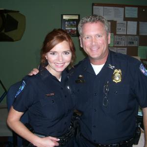 Tony Senzamici as Police Chief Stites with Brigid Brannagh as Officer Pamela Moran on the set of Army Wives. Episode 513, Farewell to Arms.