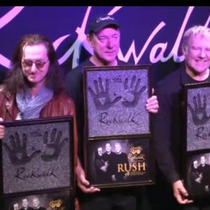 Iconic Rock Band Rush holding commemorative plaques at their induction into the RockWalk Hall of Fame Plaques Designed and fabricated by Meredith DayDreamland3Dcom