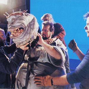 Ghostbusters 2 (1989) ILM blue screen set-up, main stage. Bob Cooper helps fit helmet-head. Barbara Hartman-Jenichen adjusts shoulders.