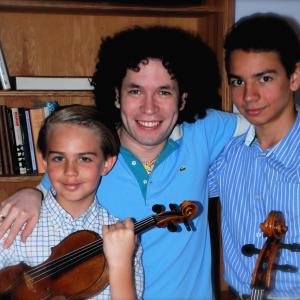 The Carrasco Brothers, Sebastian (violinist) and Juan-Salvador (cellist), with Maestro Gustavo Dudamel, conductor of The Los Angeles Philharmonic.