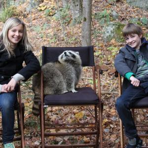 Erin Pitt CJ Adams and raccoon costar in Against The Wild