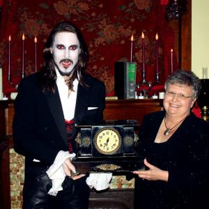 MATT WIGGINS (in DRACULA make-up) is presented a historic mantel clock from the a Board Member for the Randleman House historic home in Carlise, IA, which was selected as one of the locations used for Matt's hit live production of Bram Stokers DRACULA.