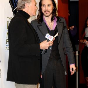 A candid moment as Matt Wiggins prepares for an interview at the Iowa Motion Picture Association's Golden Globe event in 2014.