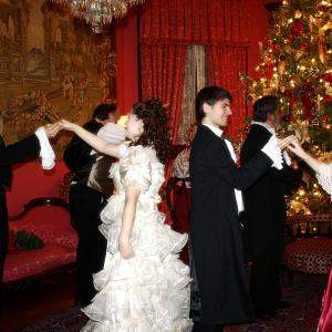 Still of Matt Wiggins as Young Scrooge with fellow cast members of the 2013 live production of Charles Dickens A Christmas Carol at the historic Terrace Hill Mansion in Iowa