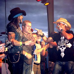 Matt Wiggins being greeted by Bret Michaels on stage in March 2014.