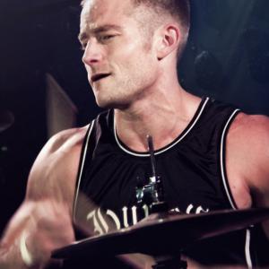 Beau DeSilva playing drums for South Bay punk band False Alliance