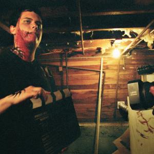 Devin Fearn helps out with the clapboard during his bloody fight scene in the basement.