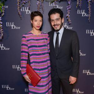 Claire Tran and Elisha Karmitz attending ELLEDior dinner Sonia by Sonia Rykiel dress and clutch Dior suit Cannes Film Festival 2014